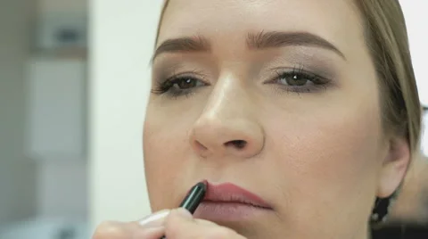 Makeup artist making make-up for stylish model Stock Footage 64639940