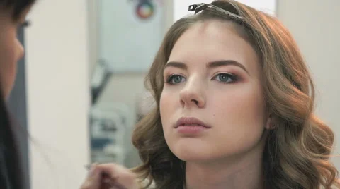 Makeup artist making make-up for stylish model Stock Footage 65320471