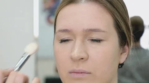 Makeup artist making make-up for young model Stock Footage 63569517