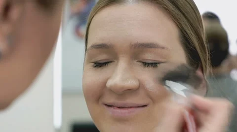 Makeup artist making make-up for young model Stock Footage 63810740