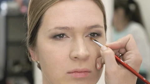 Makeup artist making make-up for young model Stock Footage 64105029
