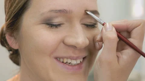 Makeup artist making make-up for young model Stock Footage 64105159