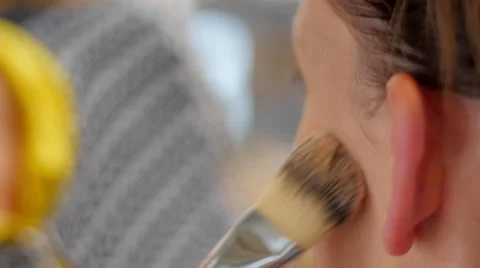 Makeup artist making up model with brush extreme closeup Video stock 59729504