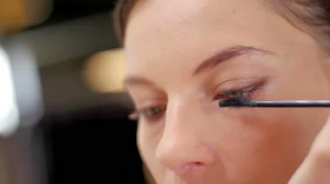 Makeup artist making up model with mascara close up Stock Footage 59729594