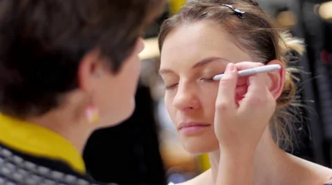 Makeup artist making up model with pen close up Stock Footage 59729734