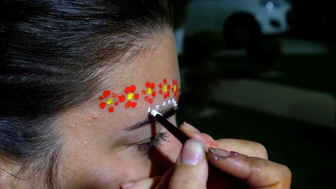 Makeup artist painting white dots on caucasian middle age woman. Stock Footage 123737143