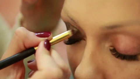 Makeup artist paints eyelids Stock Footage 74350141