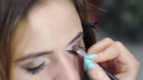 Makeup artist paints the model Stock Footage 71829306
