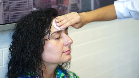 A makeup artist prepares a model Stock Footage 98481761
