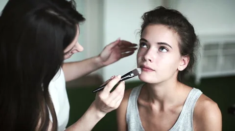 A makeup artist prepares a model to shoot Stock Footage 66823856