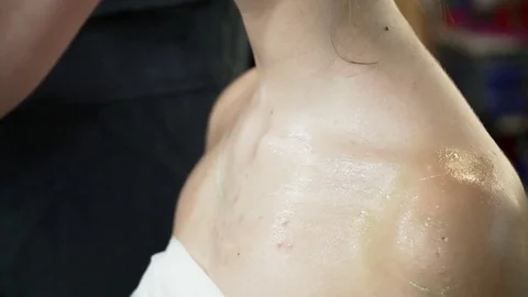 Makeup artist preparing woman's body for the body art Stock Footage 76574589