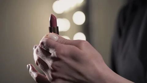Makeup artist pulls out lipstick 4k Stock Footage 154061173