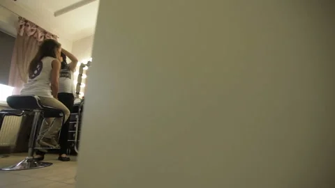 Makeup artist puts makeup on the face of the girl in the beauty salon Stock Footage 97867342