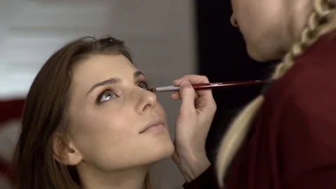 Makeup artist puts a shadow on the model Stockbeeldmateriaal 85757979