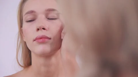 The makeup artist shades the model's eyebrows Stock Footage 142135014
