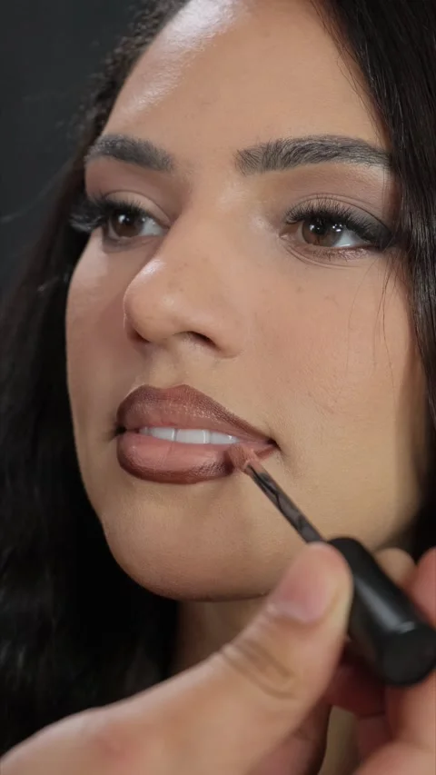 A makeup artist showcases lipstick application techniques in a tutorial Vídeos de archivo 306285841