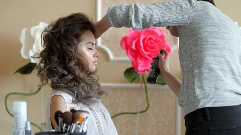 Makeup artist stylist works with model. hairdresser does the hair styling of the Stock Footage 88335953