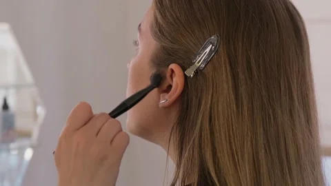 Makeup artist uses brushes and applies foundation to the model's face. Stock Footage 199839239