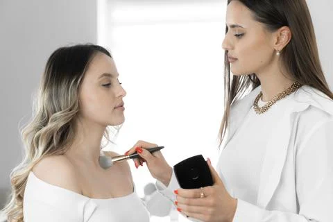 The makeup artist uses his creativity and skills to create a unique makeup that Stock Photos