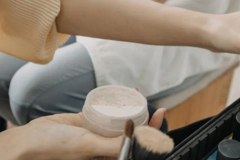 Makeup artist is using makeup tools applying to the client. Stock Photos