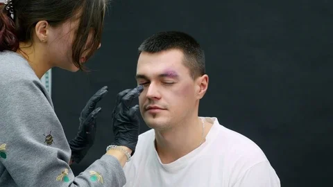 Makeup artist at work applying special effects makeup Stock Footage 83312092
