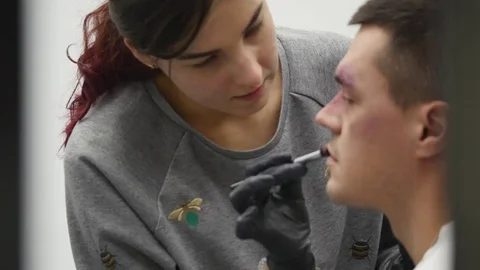 Makeup artist at work applying special effects makeup Stock Footage 83314481