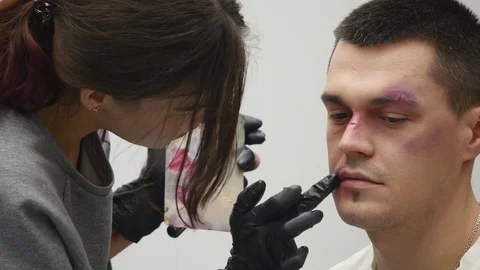 Makeup artist at work applying special effects makeup Stock Footage 83777432