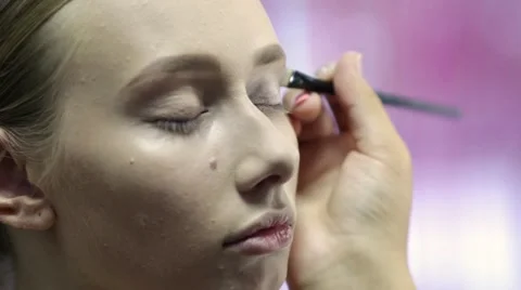 Makeup artist at work doing makeup for a young model 库存影片 67319186