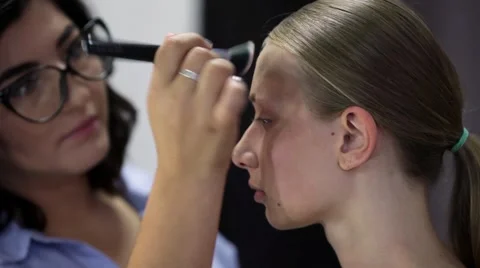 Makeup artist at work with young beauty model doing Makeup. Stock Footage