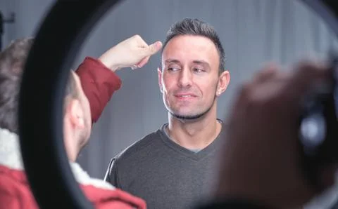 Makeup artist working on models face Stock Photos