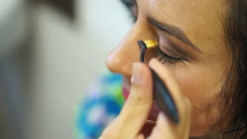 Makeup artist working with a person model Stock Footage 98482172