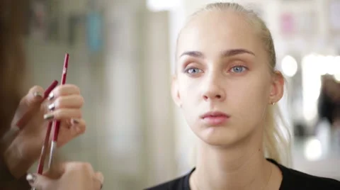 Makeup artist works on a model Stock Footage 68014356