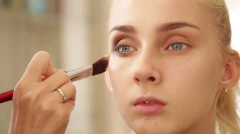 Makeup artist works on a model Stock Footage 68014988