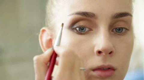 Makeup artist works on a model Stock Footage 68015268