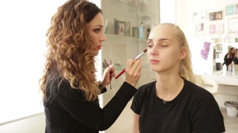 Makeup artist works on a model Stock Footage 68015488