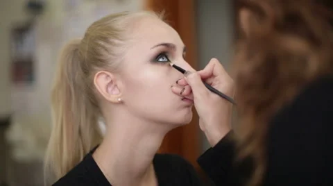 Makeup artist works on a model Stock Footage 68017448