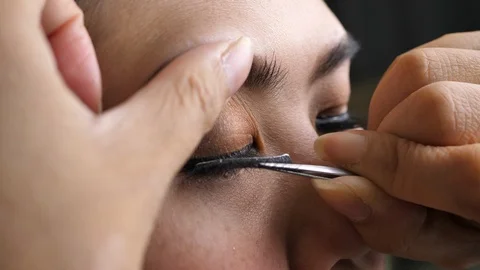 Makeup beauty paste long false eyelash on eye Stock Footage 109076871