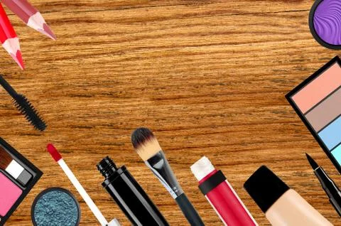 Makeup brush and cosmetics over wooden background Stock Photos