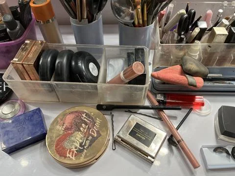 Makeup brush and cosmetics on a table for makeup artist. Stock Photos