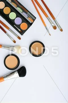 Makeup brush and cosmetics, on a white background Stock Photos