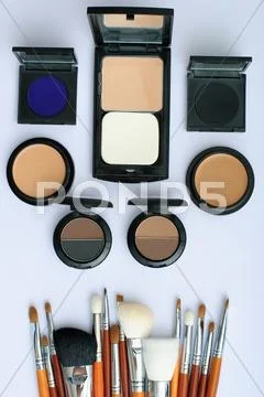 Makeup brush and cosmetics, on a white background Stock Photos