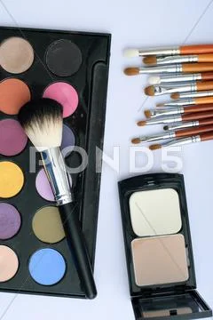 Makeup brush and cosmetics, on a white background Stock Photos