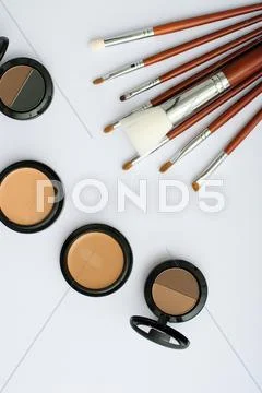 Makeup brush and cosmetics, on a white background Stock Photos