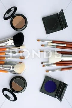 Makeup brush and cosmetics, on a white background Stock Photos