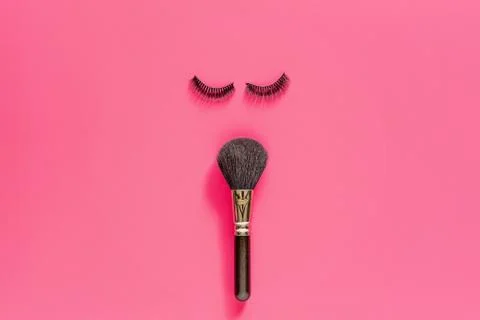 Makeup brush and False Eyelashes Lying On Pink Background. Beauty And Makeup  Stock Photos