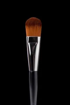 Makeup brush on a black background Stock Photos