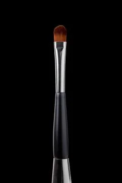 Makeup brush on a black background Stock Photos