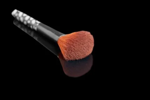 Makeup brush on a black background with reflection Stock Photos