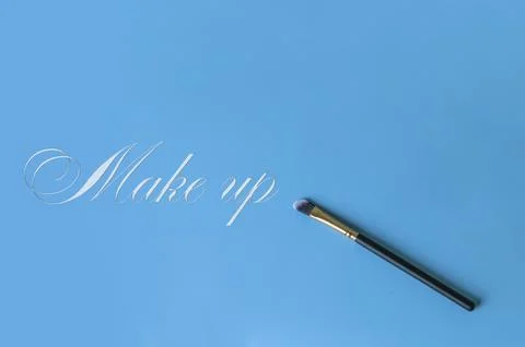 Makeup brush on a blue background Stock Photos