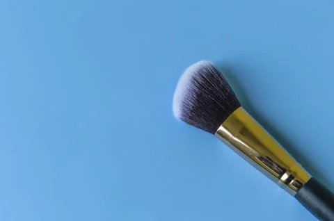 Makeup brush on a blue background Stock Photos